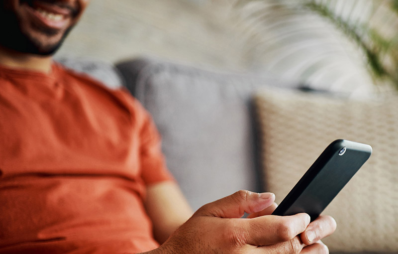 Man using phone in living room