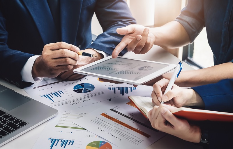 a group of investors discussing financial documents