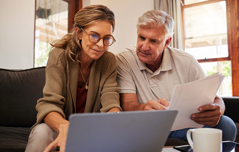 Mature couple going over finances in living room