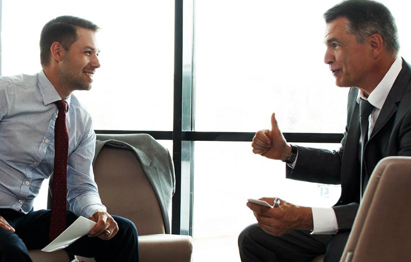 two businessmen talking to each other