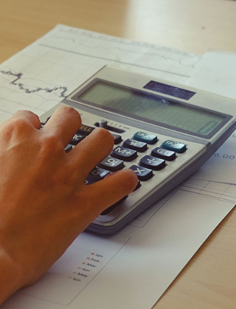 a person working on a digital calculator