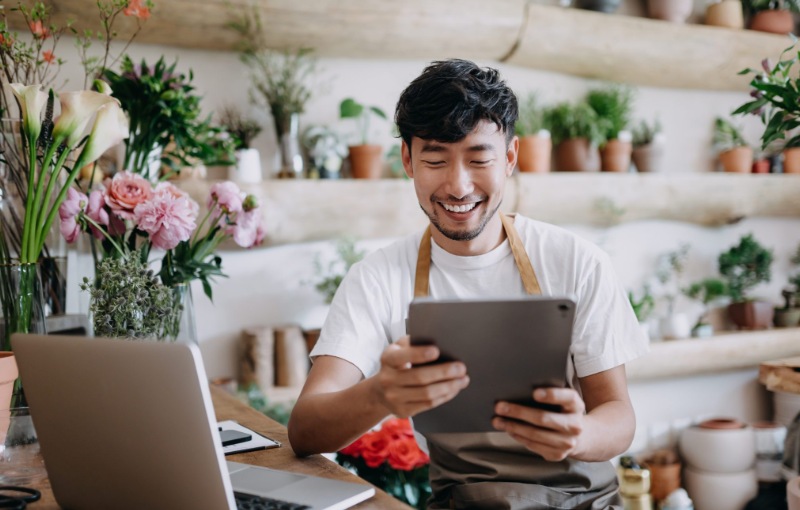 a florist looking at their tablet