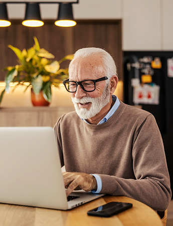 Man using computer in kitchen