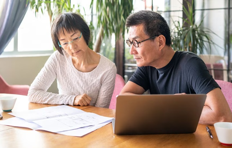 a couple reviewing paper documents