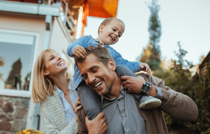 a family of three playing outside