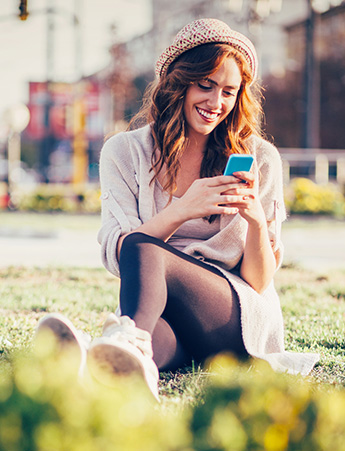 Woman looking at phone at a park