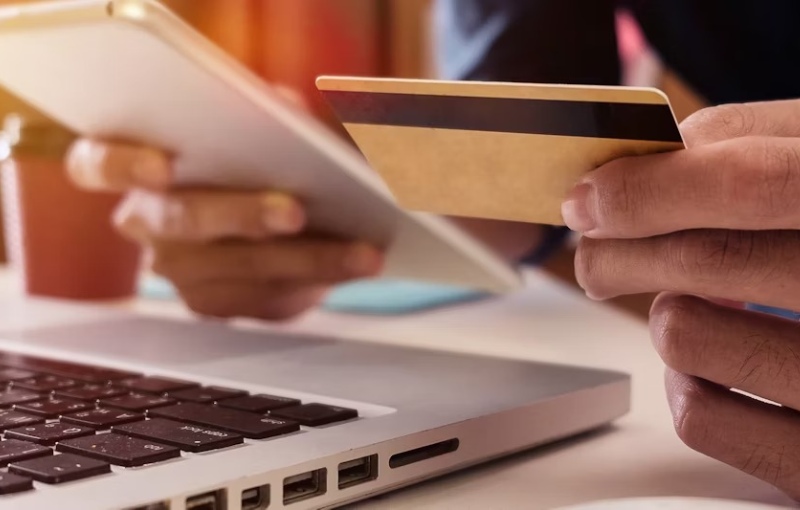 a person working on their laptop making a mobile purchase