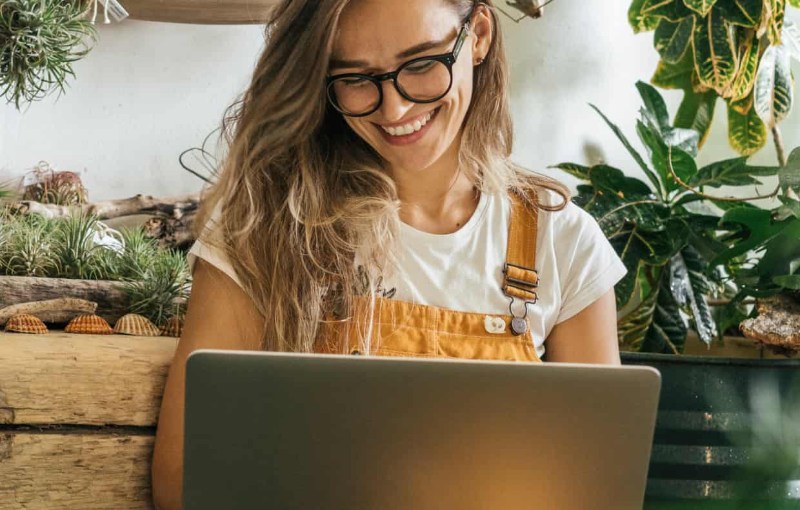 a woman looking at her laptop