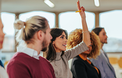 Woman raising hand to ask question