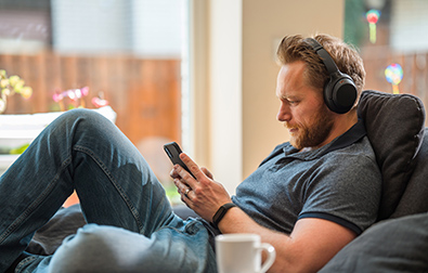 Man using phone in living room