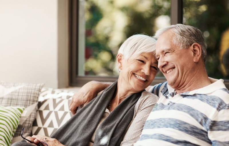 an elderly couple smiling