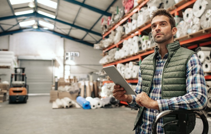 a foreman reviewing their inventory stock