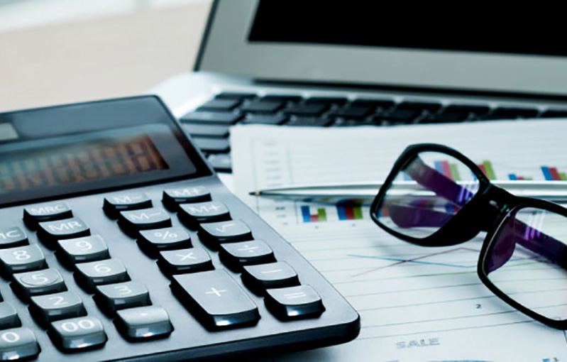 calculator next to a computer